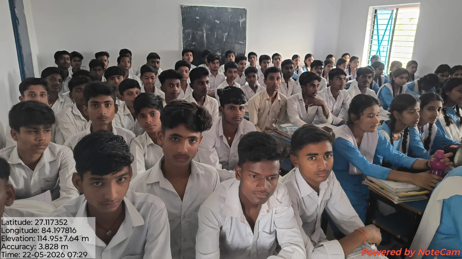 Boys and girls seated together at classroom desks